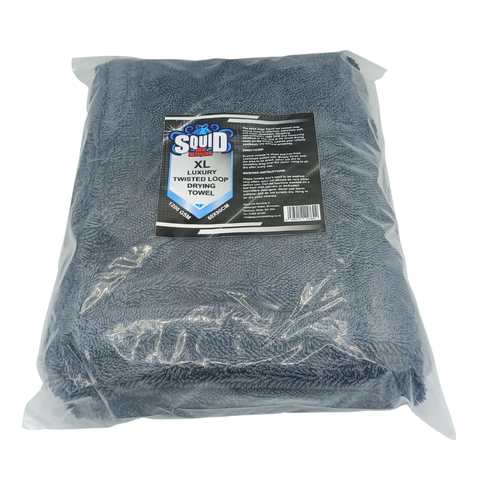 Grey XL twisted loop drying towel in a clear plastic bag with a Squid brand label on a white background